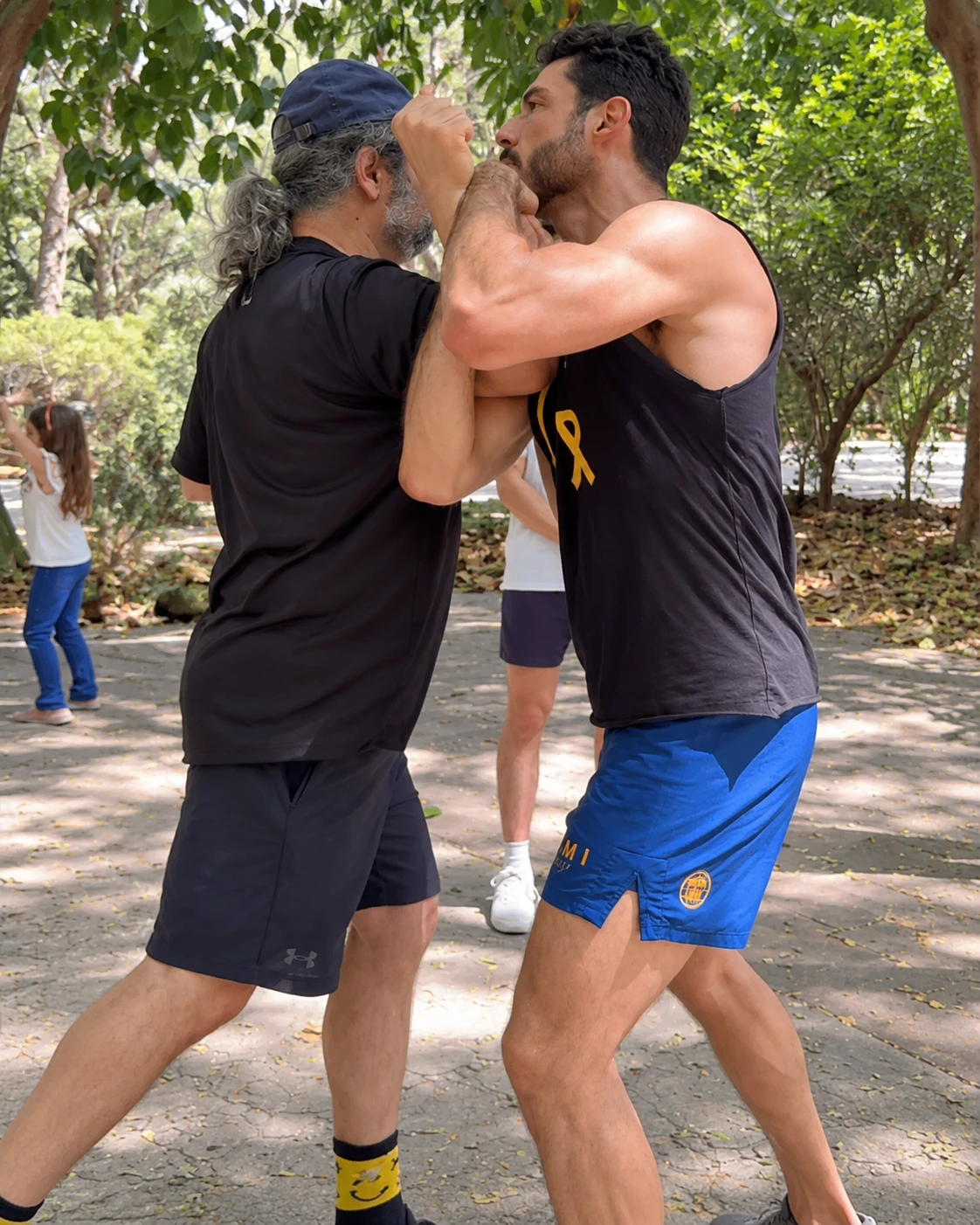 Retouched training still: close-range partner practice outdoors